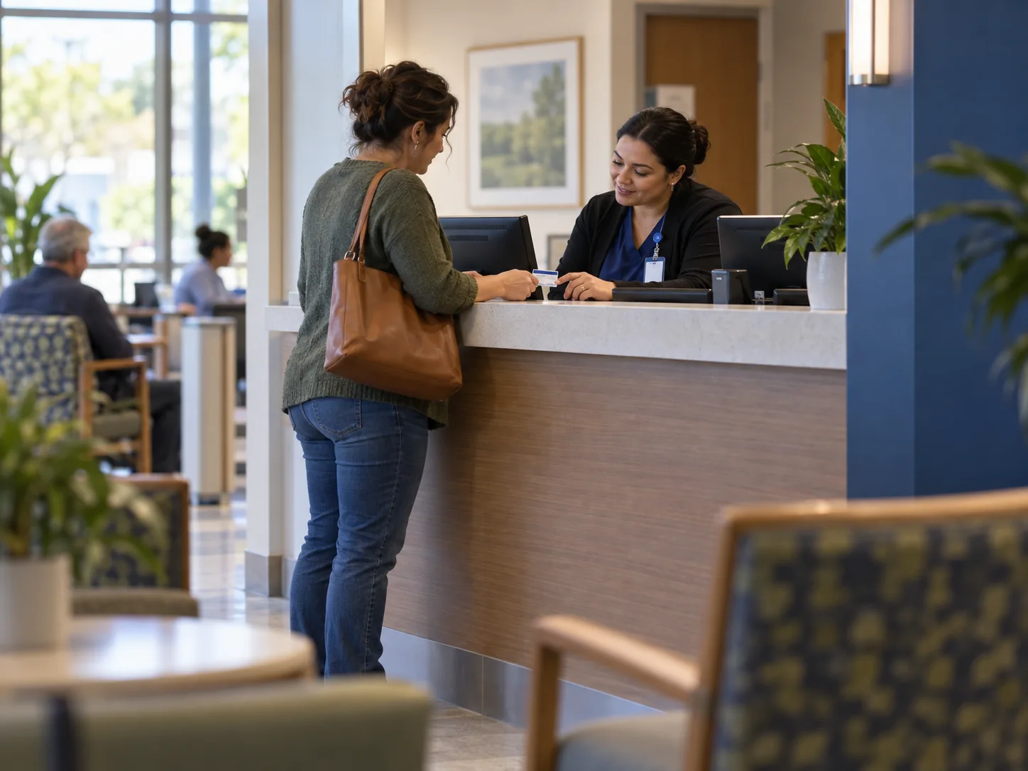 Patient access specialist reviews insurance details with a patient at registration